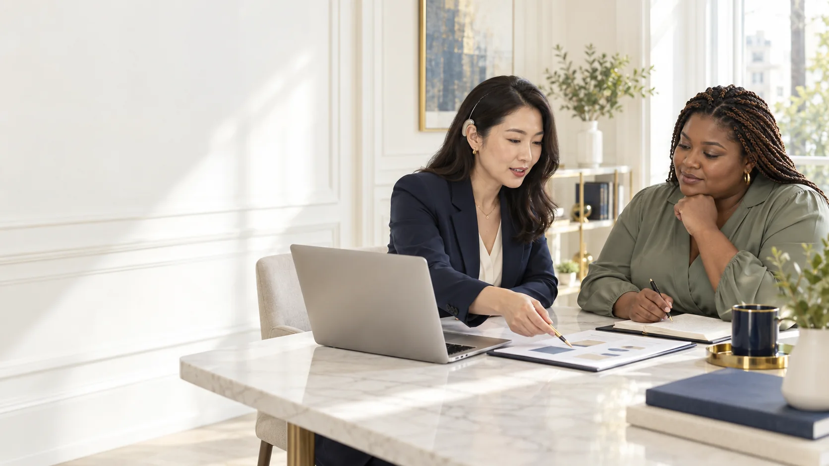 An East Asian adviser with a hearing aid guiding a Black client through an AI strategy plan